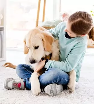 pretty little girl holding cute dog