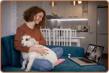 woman having conversation with doctor about esa letter with dog on laptop